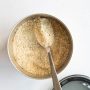 Close-up of Vital Roots Talbina powder in a container, ready to be used for making a healthy Barley Porridge or Talbina Recipe.