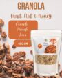 "Granola with fruits, nuts, and honey in a bag with cereal flakes and oatmeal pieces scattered on a surface"